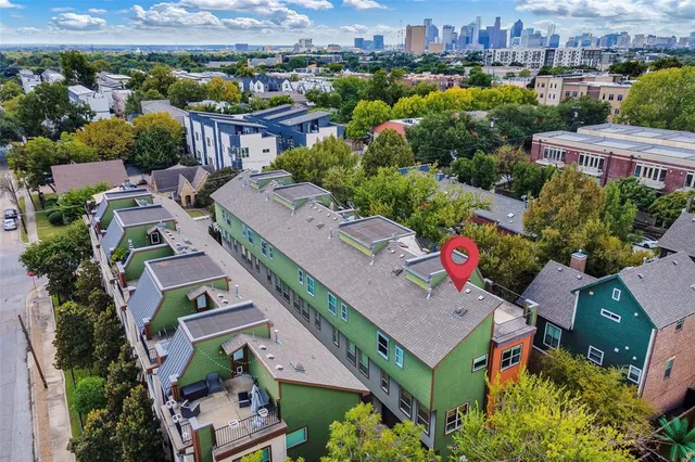 an aerial view of multiple houses with yard