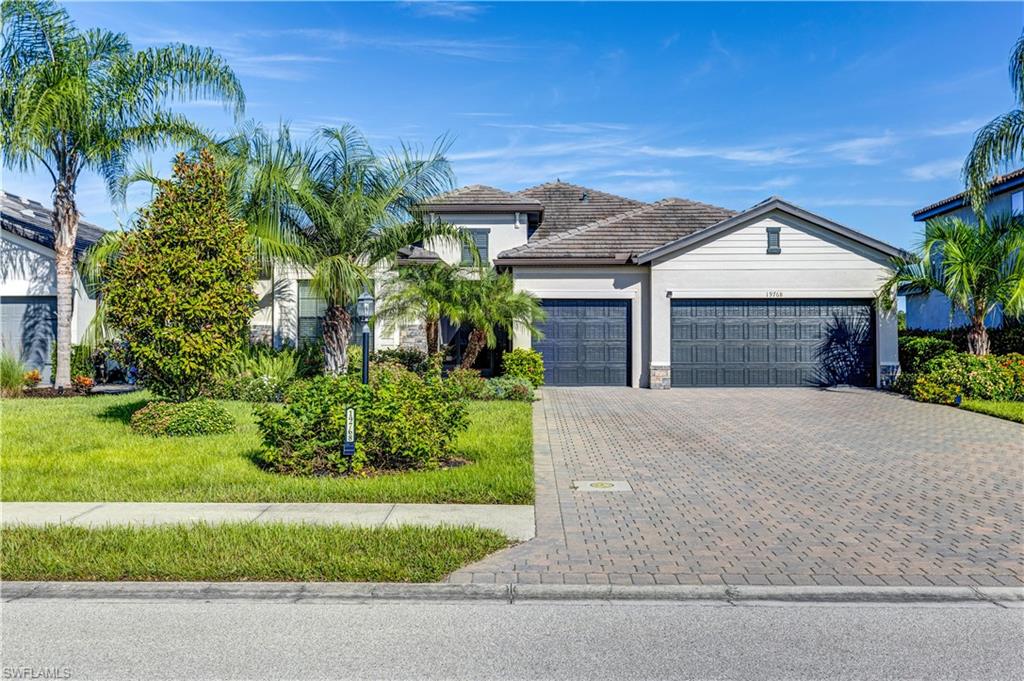 a front view of a house with a yard and garage