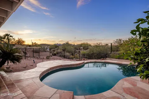 a view of a swimming pool with a yard