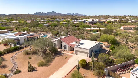 an aerial view of residential houses with outdoor space and ocean view
