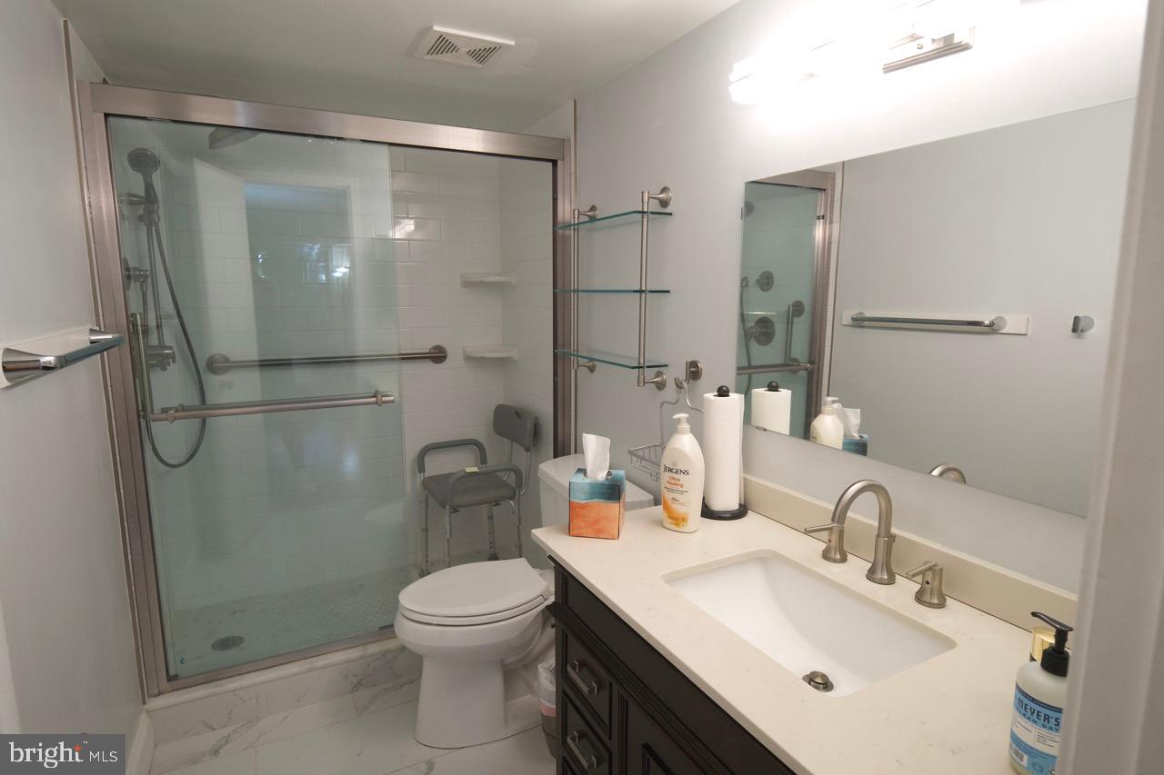 1800 Old Meadow Road, Unit 818 McLean, VA 22102 - Photo 15 of 35 a bathroom with a sink toilet and shower