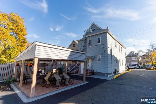 a view of a house with a patio and a yard