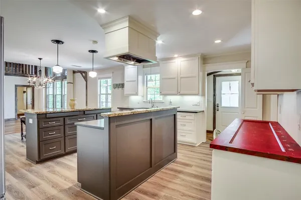 a kitchen with stainless steel appliances kitchen island granite countertop a stove and cabinets