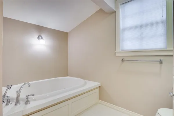 a bathroom with a bathtub and a window
