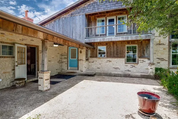 a front view of a house with outdoor seating