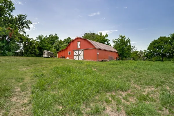 a view of a large garden with plants and large trees