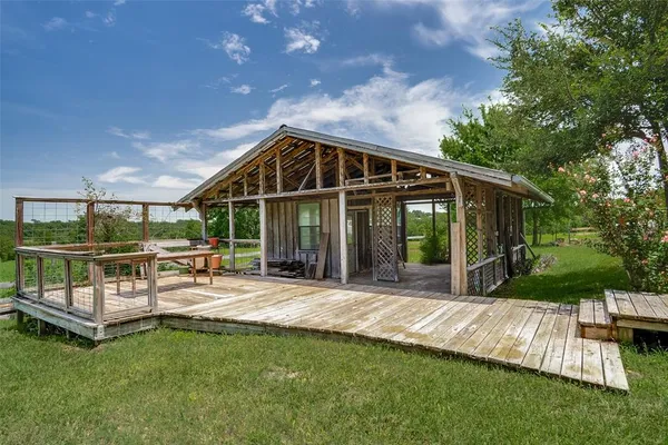 a view of a house with backyard porch and sitting area