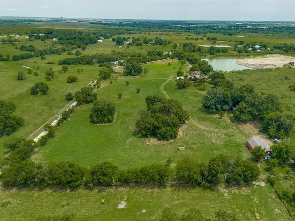 a view of a green field with lots of trees
