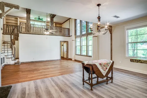 a view of a livingroom with furniture wooden floor and windows