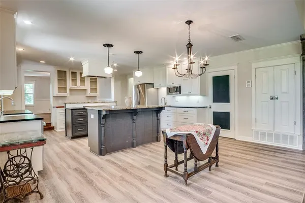 a view of a dining room with furniture and chandelier