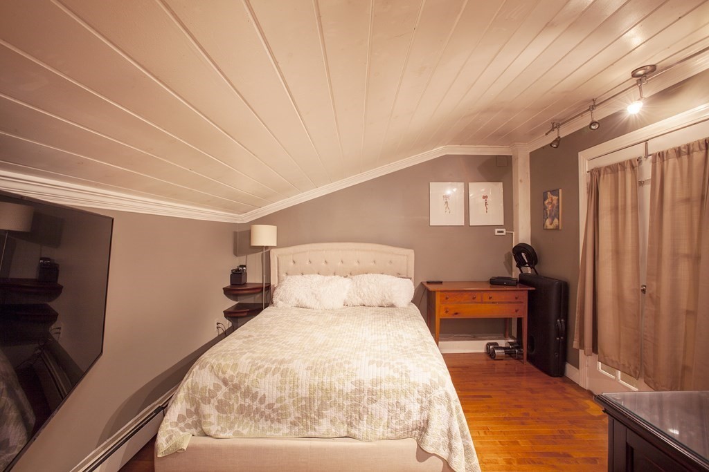 295 Stumpfield Road Hopkinton, NH 03229 - Photo 25 of 36 a bed room with a bed and a chandelier