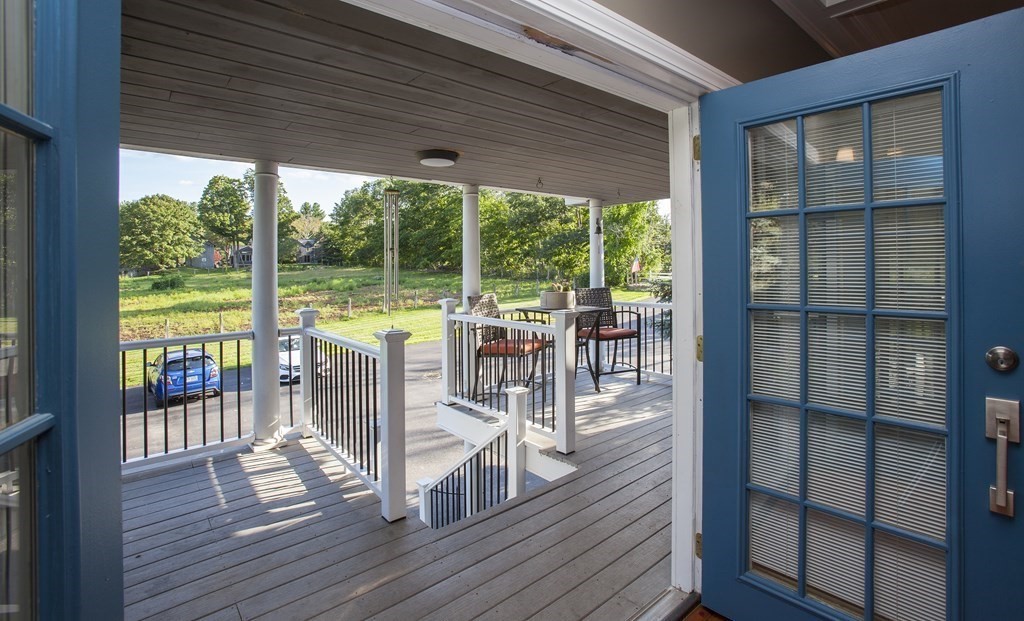 295 Stumpfield Road Hopkinton, NH 03229 - Photo 26 of 36 a view of a deck with wooden floor and floor to ceiling window