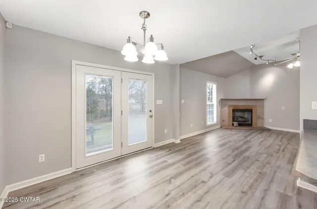 a view of a livingroom with wooden floor and a ceiling fan