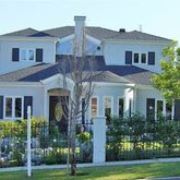 a front view of a house with yard and green space