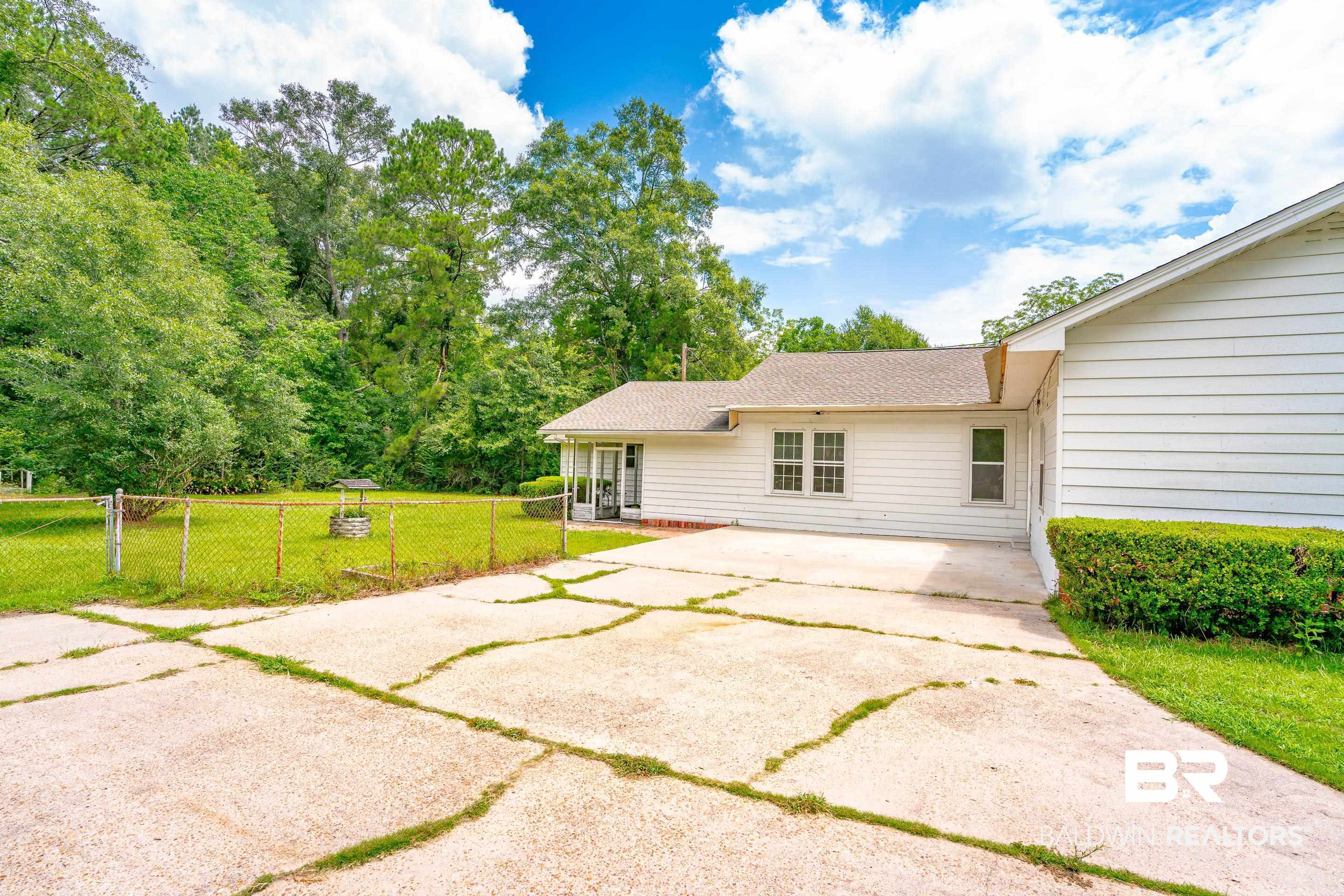 1160 Military Road Mount Vernon, AL 36560 - Photo 25 of 30 Rear view of property with a lawn