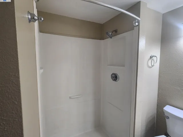 a bathroom with a shower and a toilet