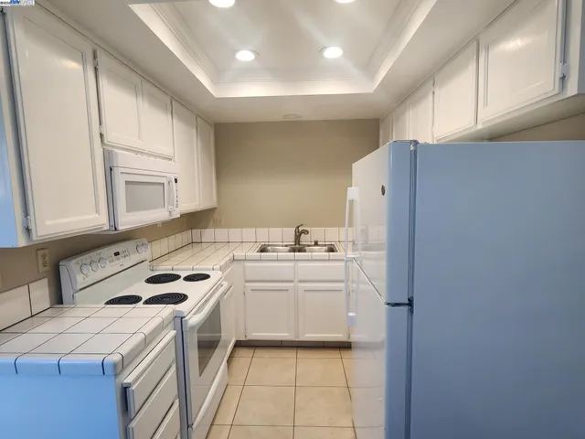 a kitchen with a sink a stove and refrigerator