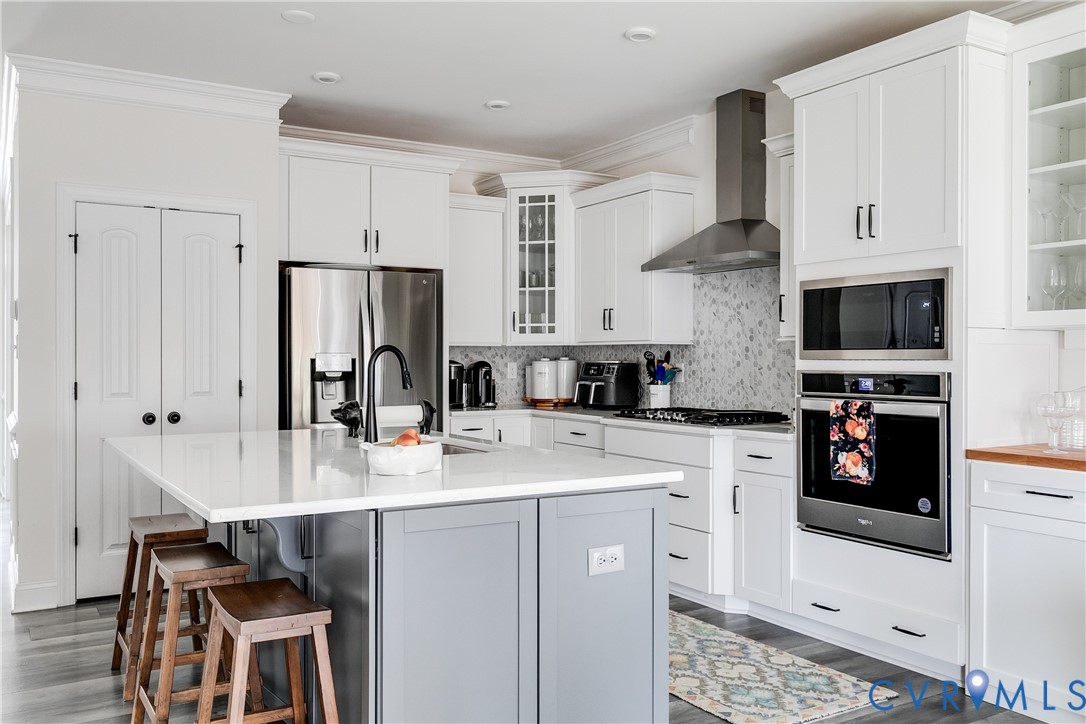 10123 Peach Blossom Road Mechanicsville, VA 23116 - Photo 13 of 49 a kitchen with stainless steel appliances a stove refrigerator sink and cabinets