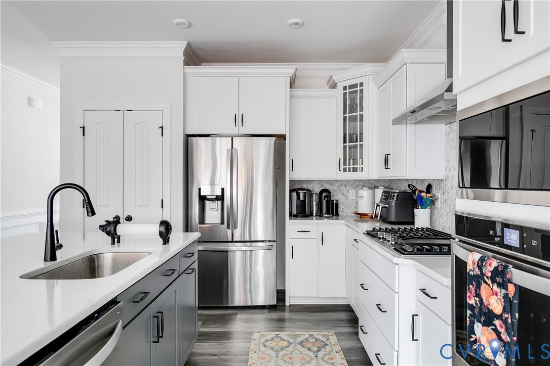 10123 Peach Blossom Road Mechanicsville, VA 23116 - Photo 14 of 49 a kitchen with stainless steel appliances a refrigerator sink and cabinets