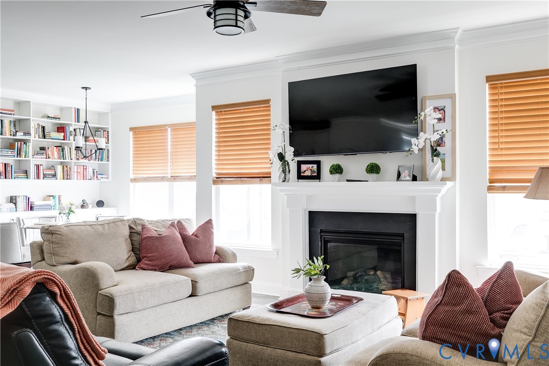 10123 Peach Blossom Road Mechanicsville, VA 23116 - Photo 23 of 49 a living room with furniture a flat screen tv and a fireplace