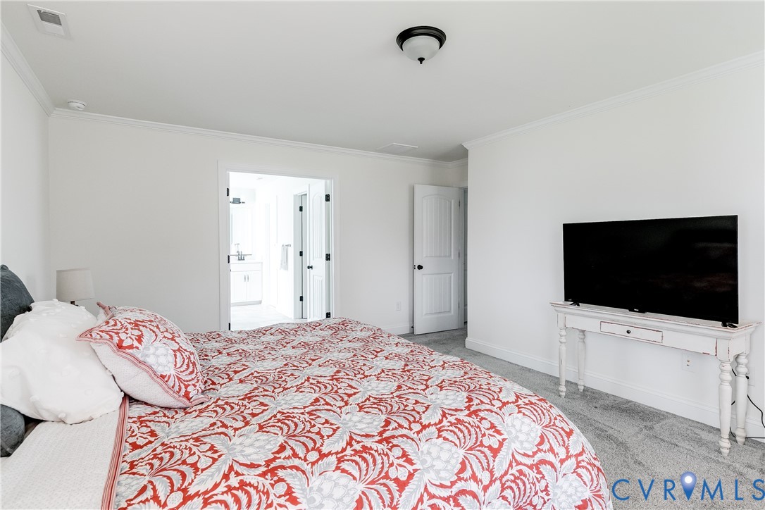 10123 Peach Blossom Road Mechanicsville, VA 23116 - Photo 30 of 49 a bedroom with a bed and a flat screen tv