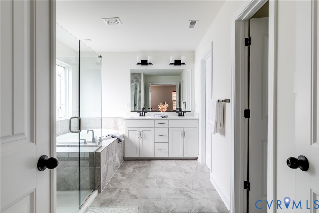 10123 Peach Blossom Road Mechanicsville, VA 23116 - Photo 31 of 49 a bathroom with a granite countertop sink mirror and bathtub