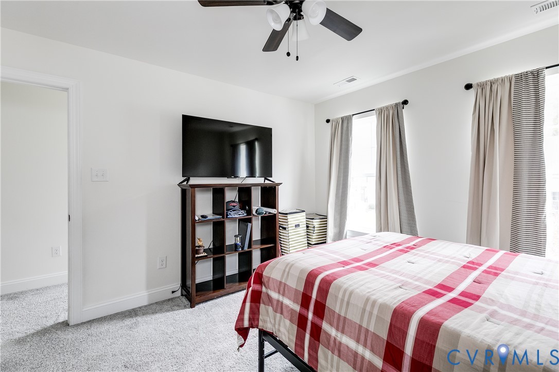 10123 Peach Blossom Road Mechanicsville, VA 23116 - Photo 40 of 49 a bedroom with a bed and a book shelf