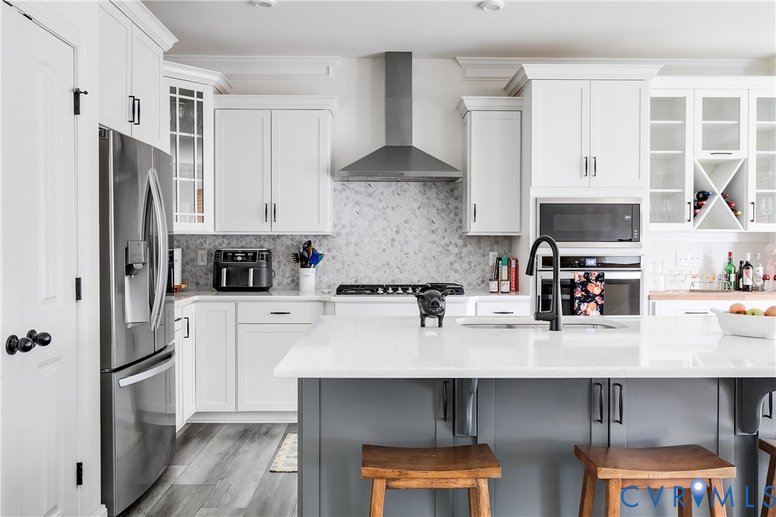 10123 Peach Blossom Road Mechanicsville, VA 23116 - Photo 9 of 49 a kitchen with stainless steel appliances a sink a stove a refrigerator and cabinets