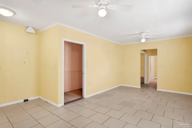 a backyard of a house with large trees and brick wall