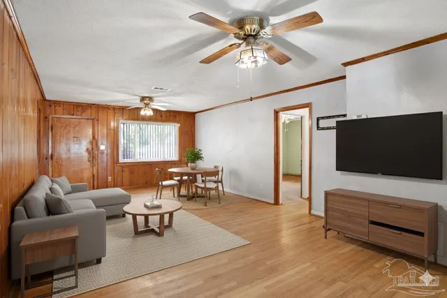 a view of kitchen with wooden floor and cabinets