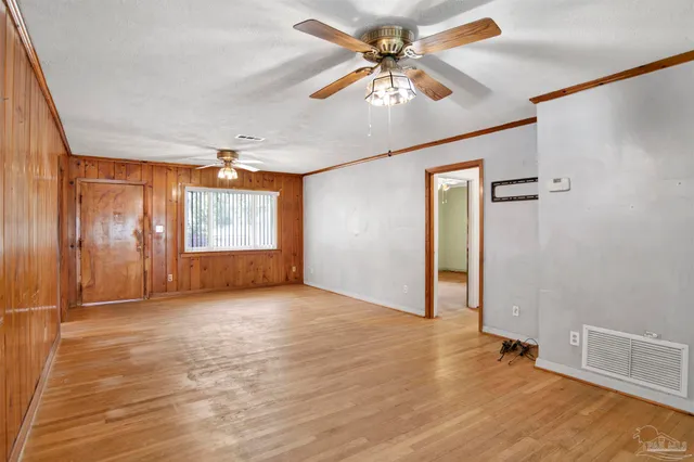a kitchen with stainless steel appliances granite countertop a sink window and cabinets