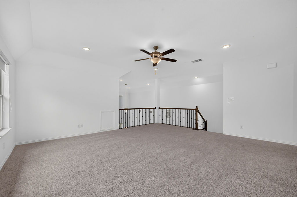 1332 Ridge Runner Drive Georgetown, TX 78628 - Photo 26 of 40 A spacious secondary living area features soft carpeting, recessed lighting, and a ceiling fan, creating an inviting atmosphere.