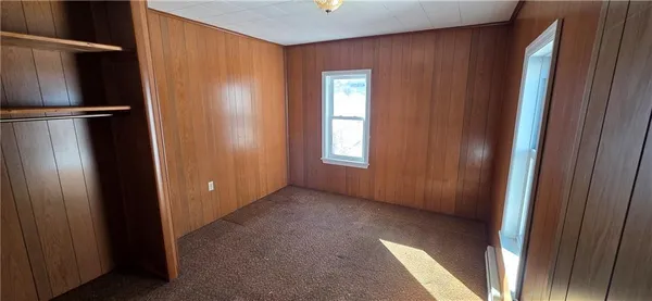 a view of a hallway with furniture and a window