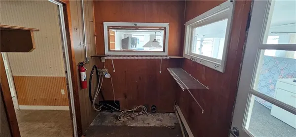 an empty room with windows and closet