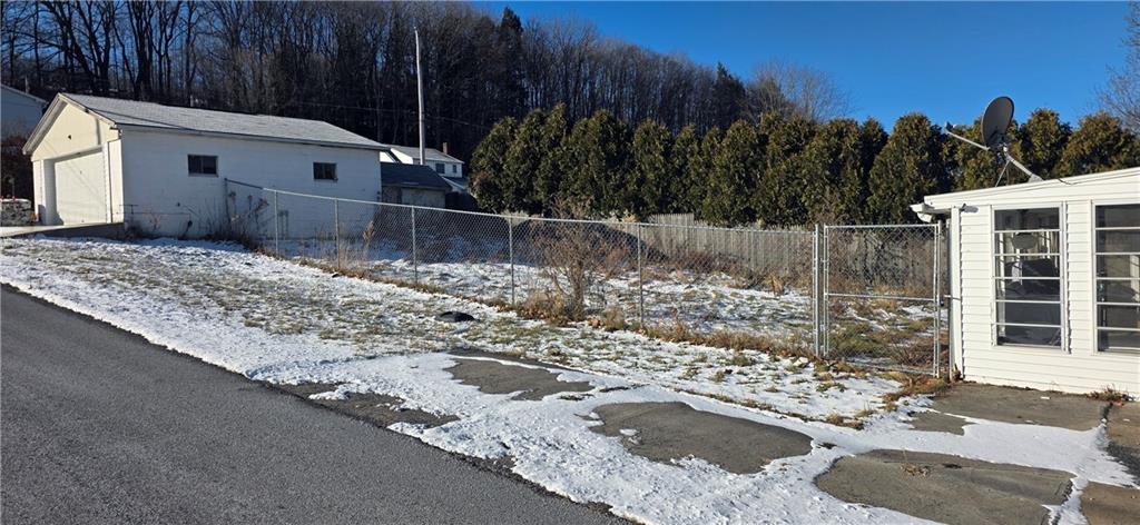201 Adele Street Lilly, PA 15938 - Photo 18 of 25 a view of a white house with a yard and wooden fence