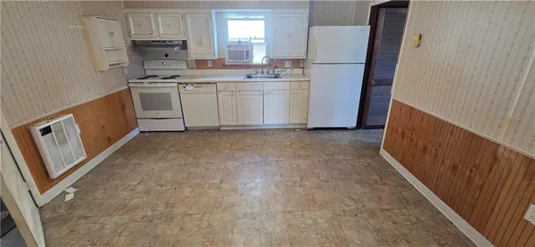 a kitchen with refrigerator a stove a microwave and cabinets