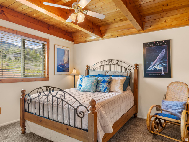371 Lewis Loop, Unit 29 Fish Haven, ID 83287 - Photo 27 of 40 Bedroom featuring a vaulted wood-beam ceiling, wood-finish window trim, a ceiling fan with integrated lighting, and carpet flooring
