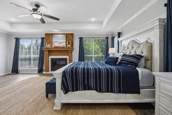 a bedroom with a bed and a fireplace