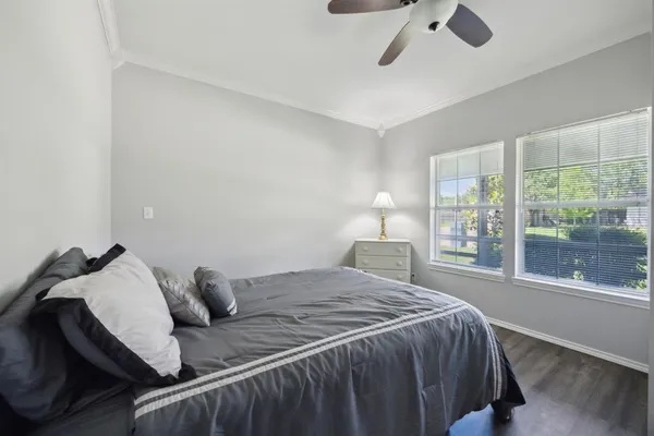 a bedroom with a bed and a large window