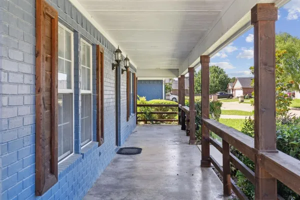 a view of a porch with chairs and backyard