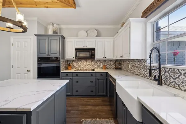 a kitchen with a sink stove top oven and refrigerator