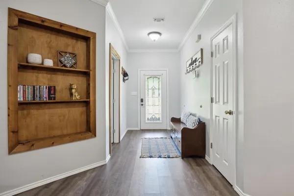a view of a hallway with wooden floor and closet