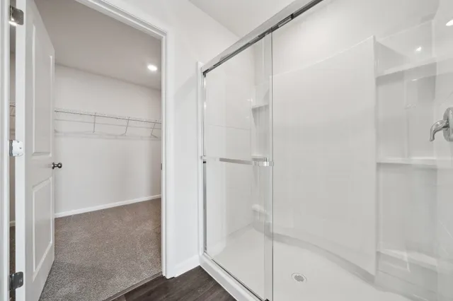 a bathroom with a glass shower door