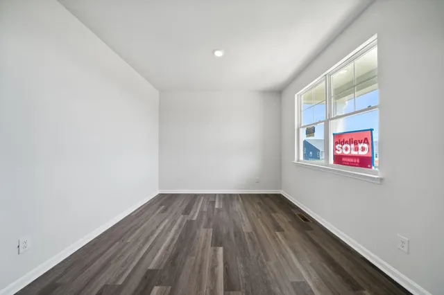 a view of room with wooden floor and fan
