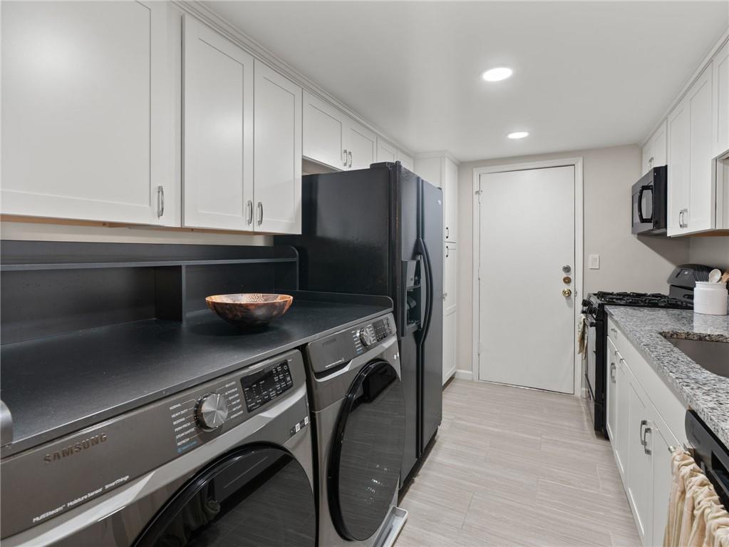 6851 Roswell Road, Unit H26 Atlanta, GA 30328 - Photo 10 of 49 a kitchen with stainless steel appliances granite countertop a sink stove and refrigerator
