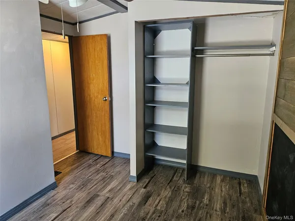 a view of walk in closet with empty racks