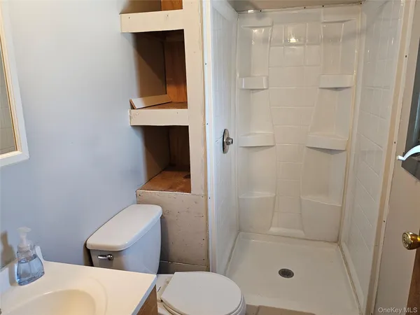a bathroom with a toilet and a shower