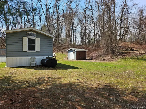 a front view of house with yard and trees