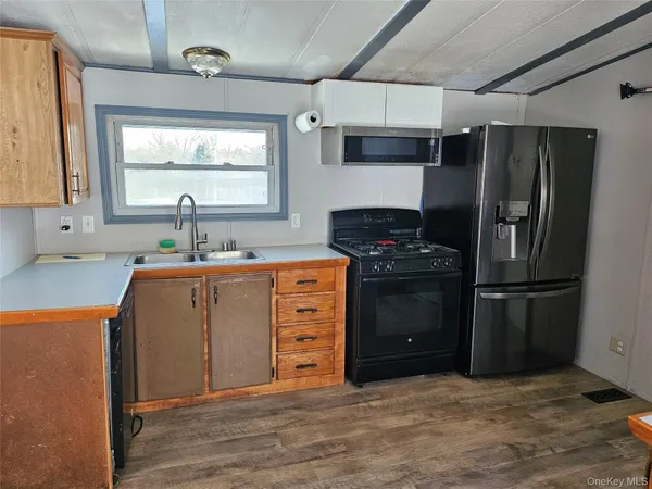 a kitchen with a refrigerator sink and cabinets