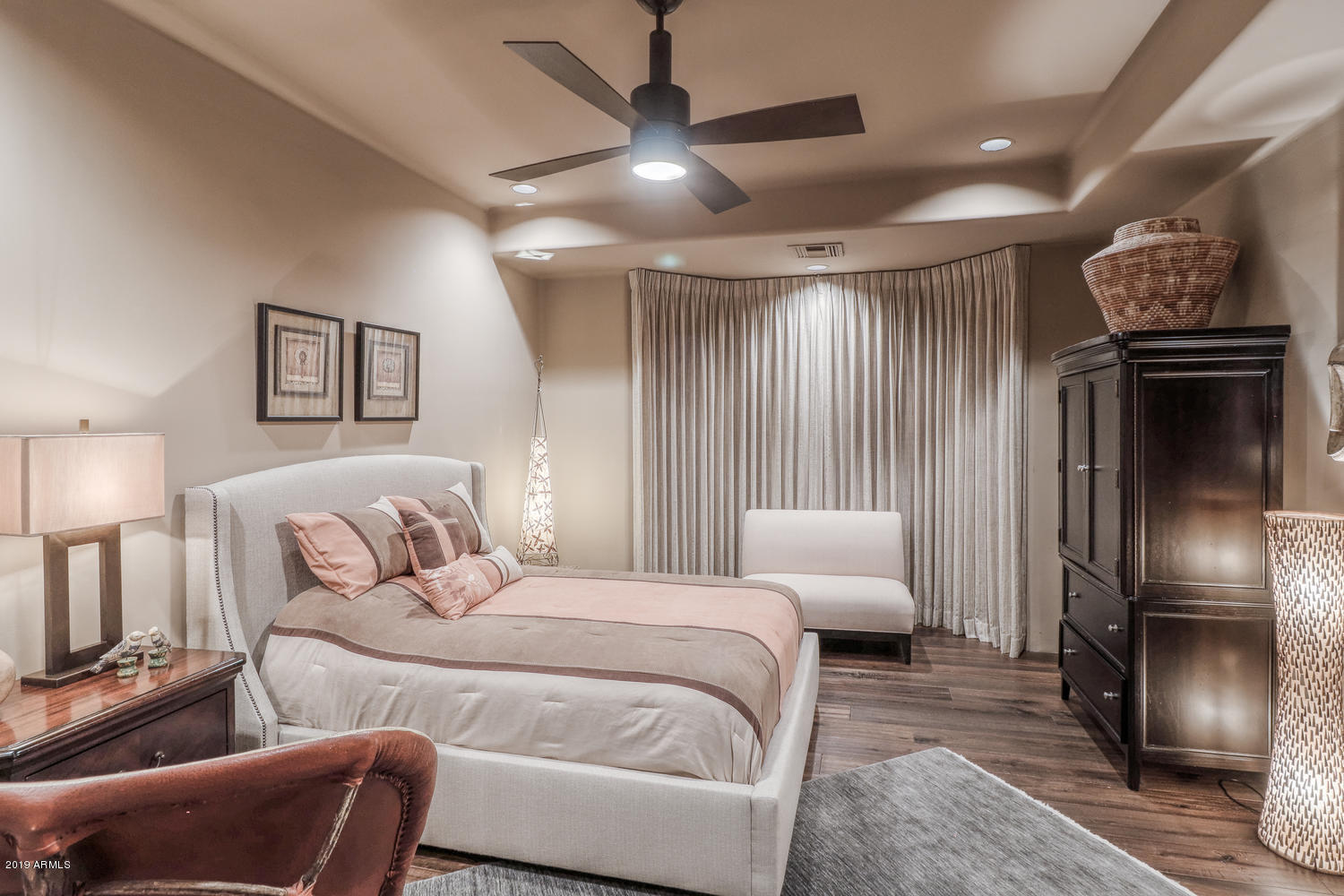 10040 East Happy Valley Road, Unit 442 Scottsdale, AZ 85255 - Photo 34 of 78 a bedroom with furniture and a chandelier